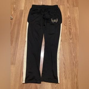 Women’s sweatpants size medium brand Augusta sports color black and mustard